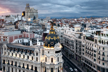Fototapeta premium Aerial cityscape of Madrid with the famous Metropolis building at sunset in Madrid, Spain
