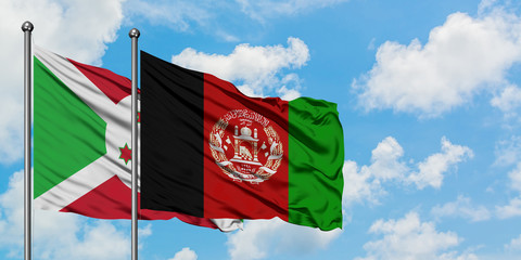 Burundi and Afghanistan flag waving in the wind against white cloudy blue sky together. Diplomacy...
