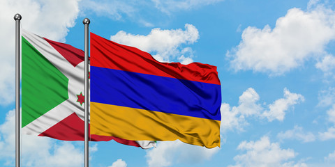 Burundi and Armenia flag waving in the wind against white cloudy blue sky together. Diplomacy concept, international relations.