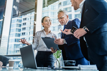 Business colleagues discussing over report document at work
