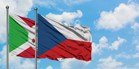 Burundi and Czech Republic flag waving in the wind against white cloudy blue sky together. Diplomacy concept, international relations.