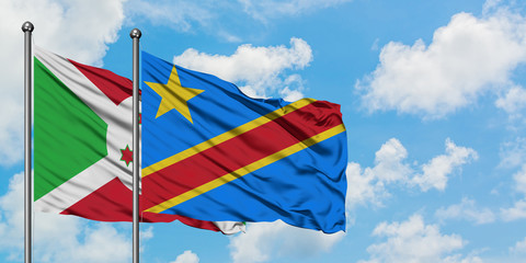 Burundi and Congo flag waving in the wind against white cloudy blue sky together. Diplomacy concept, international relations.