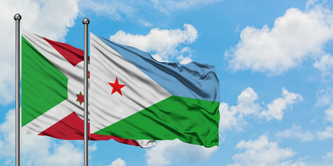Burundi and Djibouti flag waving in the wind against white cloudy blue sky together. Diplomacy concept, international relations.