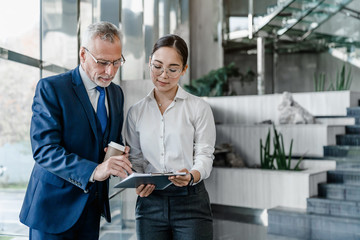 Two business people discussing about work at office stairs