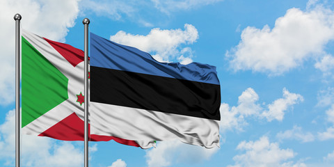 Burundi and Estonia flag waving in the wind against white cloudy blue sky together. Diplomacy concept, international relations.