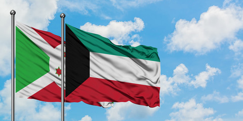 Burundi and Kuwait flag waving in the wind against white cloudy blue sky together. Diplomacy concept, international relations.