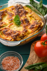 Delicious Lasagna, Italian cuisine. Pasta. Vertical frame with ingredients.