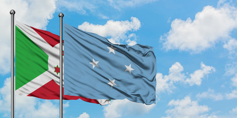 Burundi and Micronesia flag waving in the wind against white cloudy blue sky together. Diplomacy concept, international relations.