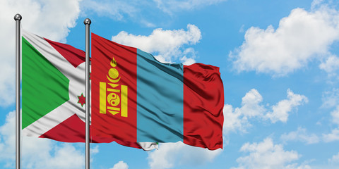 Burundi and Mongolia flag waving in the wind against white cloudy blue sky together. Diplomacy concept, international relations.