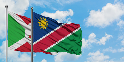Burundi and Namibia flag waving in the wind against white cloudy blue sky together. Diplomacy concept, international relations.