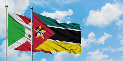 Burundi and Mozambique flag waving in the wind against white cloudy blue sky together. Diplomacy...