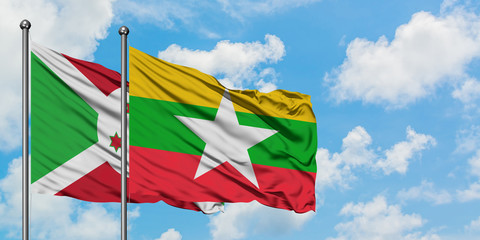 Burundi and Myanmar flag waving in the wind against white cloudy blue sky together. Diplomacy concept, international relations.