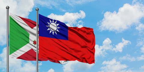 Burundi and Taiwan flag waving in the wind against white cloudy blue sky together. Diplomacy concept, international relations.