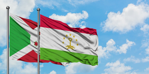 Burundi and Tajikistan flag waving in the wind against white cloudy blue sky together. Diplomacy concept, international relations.
