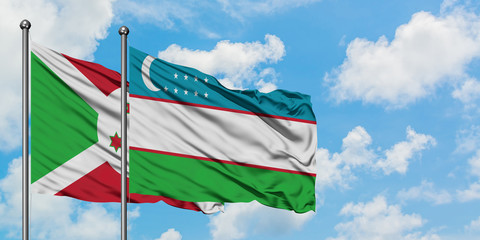 Burundi and Uzbekistan flag waving in the wind against white cloudy blue sky together. Diplomacy concept, international relations.