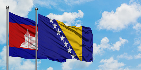 Cambodia and Bosnia Herzegovina flag waving in the wind against white cloudy blue sky together. Diplomacy concept, international relations.