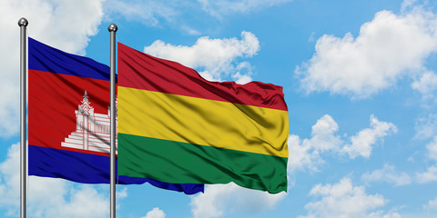 Cambodia and Bolivia flag waving in the wind against white cloudy blue sky together. Diplomacy concept, international relations.