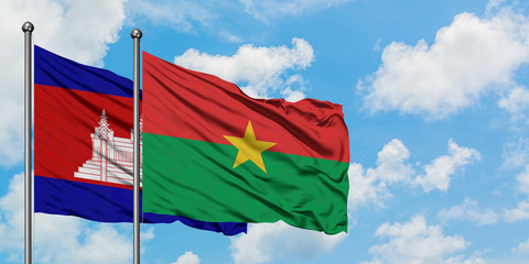 Cambodia and Burkina Faso flag waving in the wind against white cloudy blue sky together. Diplomacy concept, international relations.