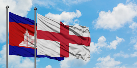 Cambodia and England flag waving in the wind against white cloudy blue sky together. Diplomacy concept, international relations.