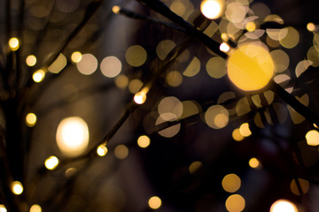 Abstract Christmas golden background. Blurred New year garlands lights.
