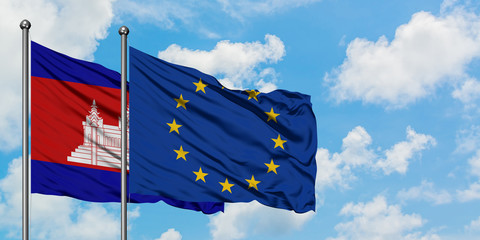 Cambodia and European Union flag waving in the wind against white cloudy blue sky together....
