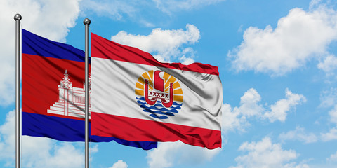 Cambodia and French Polynesia flag waving in the wind against white cloudy blue sky together. Diplomacy concept, international relations.