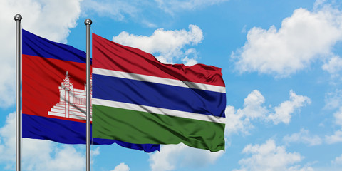 Cambodia and Gambia flag waving in the wind against white cloudy blue sky together. Diplomacy concept, international relations.