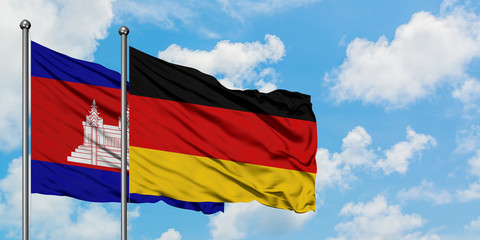Cambodia and Germany flag waving in the wind against white cloudy blue sky together. Diplomacy concept, international relations.