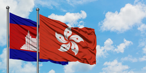 Cambodia and Hong Kong flag waving in the wind against white cloudy blue sky together. Diplomacy concept, international relations.