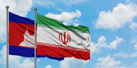 Cambodia and Iran flag waving in the wind against white cloudy blue sky together. Diplomacy concept, international relations.