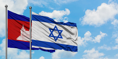 Cambodia and Israel flag waving in the wind against white cloudy blue sky together. Diplomacy concept, international relations.