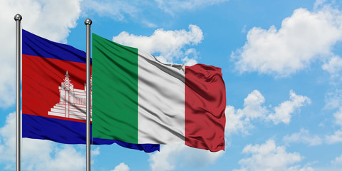 Cambodia and Italy flag waving in the wind against white cloudy blue sky together. Diplomacy concept, international relations.