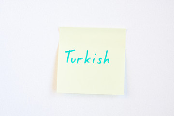 Top view flat lay of turkish language which written on the reminder notepaper of different colors.
