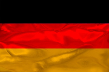 beautiful photo of the colored national flag of the modern state of Germany on textured fabric, concept of tourism, emigration, economics and politics, closeup