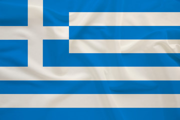 National flag of the country Greece on delicate silk with wind folds, travel concept, immigration, politics, copy space, close-up