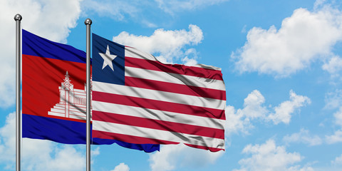 Cambodia and Liberia flag waving in the wind against white cloudy blue sky together. Diplomacy concept, international relations.