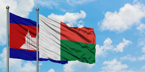 Cambodia and Madagascar flag waving in the wind against white cloudy blue sky together. Diplomacy concept, international relations.