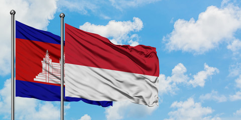 Cambodia and Monaco flag waving in the wind against white cloudy blue sky together. Diplomacy concept, international relations.
