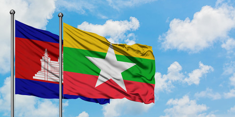 Cambodia and Myanmar flag waving in the wind against white cloudy blue sky together. Diplomacy concept, international relations.