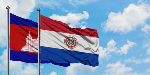 Cambodia and Paraguay flag waving in the wind against white cloudy blue sky together. Diplomacy concept, international relations.