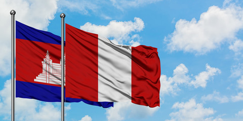 Cambodia and Peru flag waving in the wind against white cloudy blue sky together. Diplomacy concept, international relations.