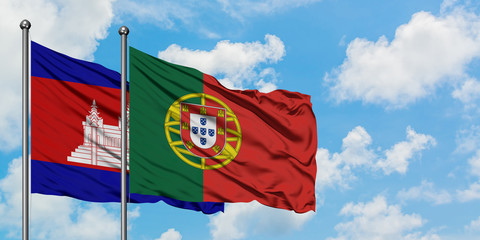 Cambodia and Portugal flag waving in the wind against white cloudy blue sky together. Diplomacy concept, international relations.