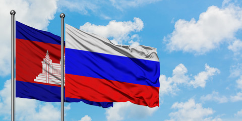 Cambodia and Russia flag waving in the wind against white cloudy blue sky together. Diplomacy concept, international relations.