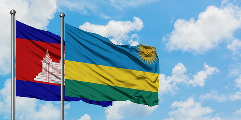 Cambodia and Rwanda flag waving in the wind against white cloudy blue sky together. Diplomacy concept, international relations.