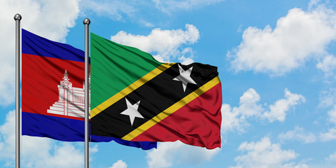 Cambodia and Saint Kitts And Nevis flag waving in the wind against white cloudy blue sky together. Diplomacy concept, international relations.