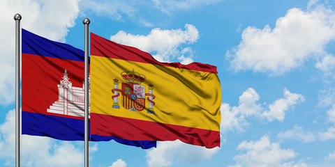 Cambodia and Spain flag waving in the wind against white cloudy blue sky together. Diplomacy concept, international relations.
