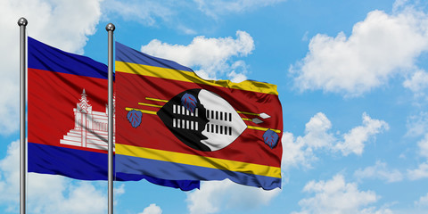 Cambodia and Swaziland flag waving in the wind against white cloudy blue sky together. Diplomacy concept, international relations.