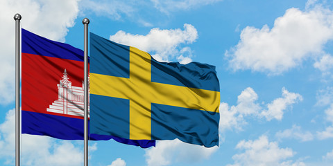 Cambodia and Sweden flag waving in the wind against white cloudy blue sky together. Diplomacy concept, international relations.