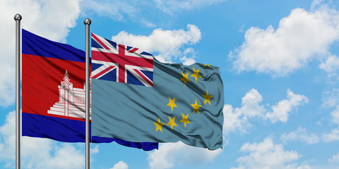 Cambodia and Tuvalu flag waving in the wind against white cloudy blue sky together. Diplomacy...