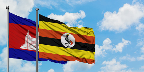 Cambodia and Uganda flag waving in the wind against white cloudy blue sky together. Diplomacy concept, international relations.